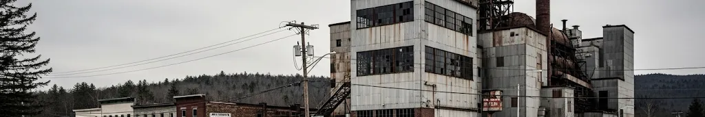 Boarded-up mill buildings in a Maine town